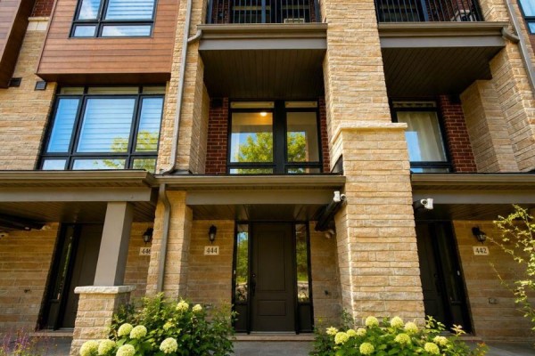 Open concept living area with hardwood floors, kitchen island, and large window. - 444 Salem Road S, Ajax