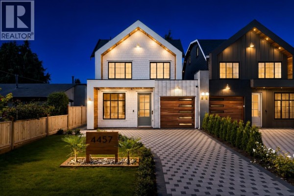 Front exterior of the left duplex home (4457) at night with illuminated windows and modern architectural features. - 4457 46a Street, Delta