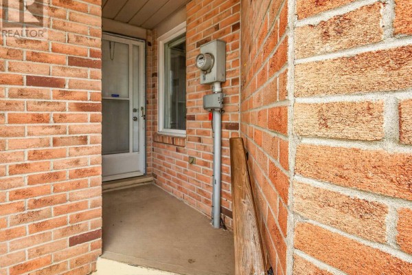 Detail of the brick exterior near the front door, showing a meter and window. - 4459 Christopher Court, Lincoln
