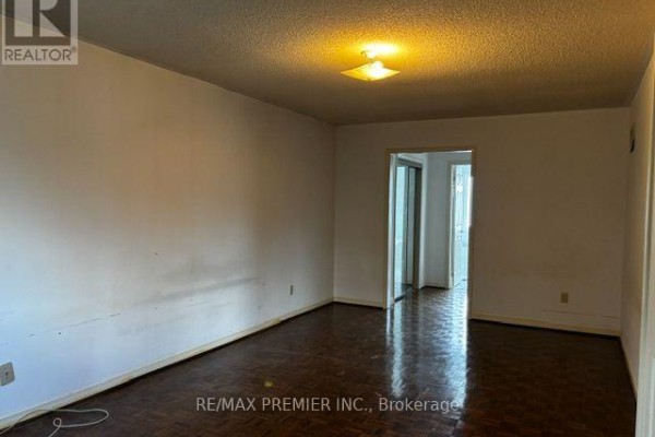 Living room with parquet flooring and doorway - 4464 Stonemill Court Mississauga