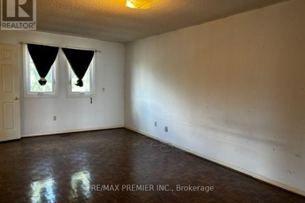 Bedroom with wood parquet floors and dark curtains - 4464 Stonemill Court Mississauga