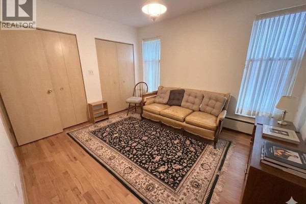 Living room with sofa, ornate rug, and hardwood floors - 4470 Riverside Windsor