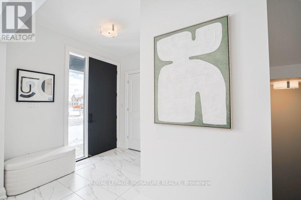 Entryway with marble flooring, modern art piece, and large front door leading outside. - 448 York Downs Boulevard, Markham