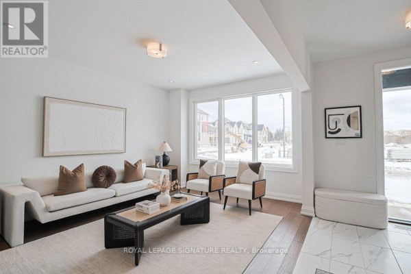 Bright living room with large windows, modern furniture, and a view of the snowy landscape. - 448 York Downs Boulevard, Markham
