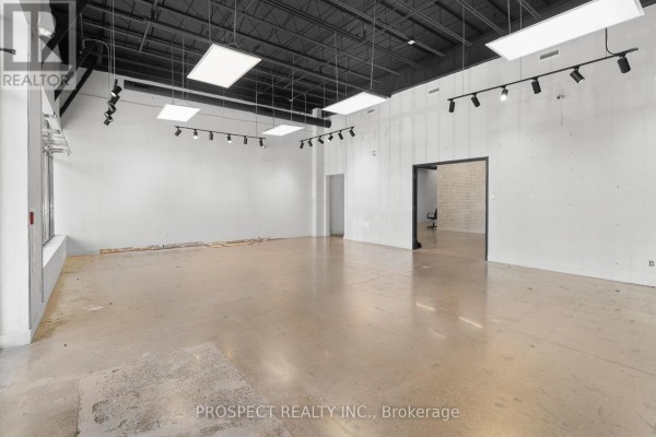 Empty commercial space with concrete floors and a doorway to another room. - 44b - 4000 Steeles Avenue W, Vaughan