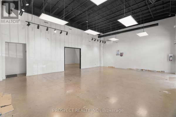 Wide view of an empty commercial space with white walls and concrete floors. - 44b - 4000 Steeles Avenue W, Vaughan