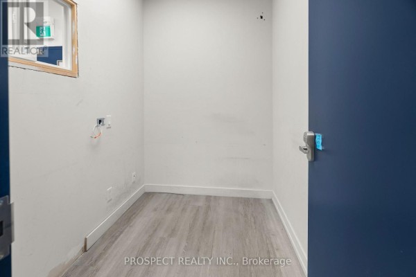 Corner of an office showing a filing cabinet, exposed wires, and computer monitor. - 44d - 4000 Steeles Avenue, Vaughan