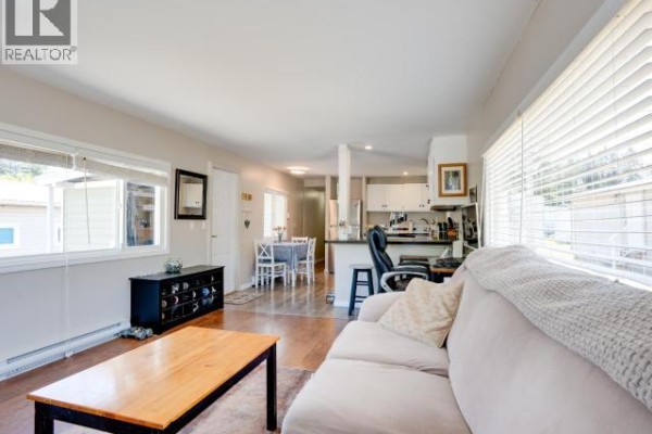Interior hallway with light wood floors and multiple white doors. - 45-4500 Claridge Road, Powell River
