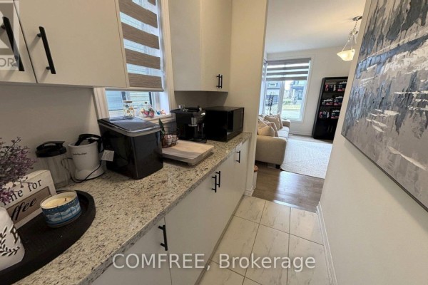 Kitchen counter with appliances, cabinets, and view into living room. - 45 Del Ray Crescent, Wasaga Beach