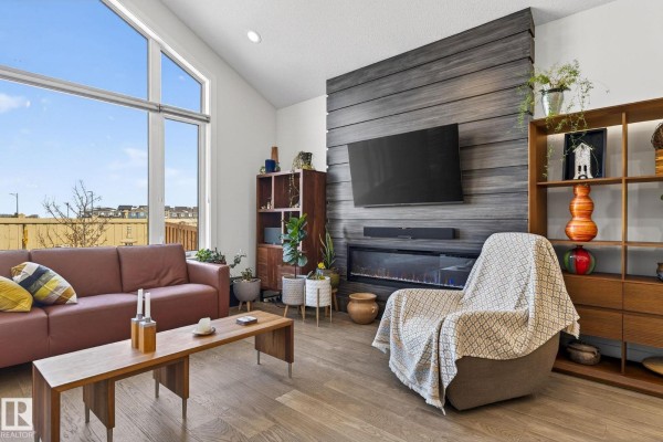 Bedroom with a bed, dresser, armchair, and wall-mounted television. - 45 Evermore Cr, St  Albert