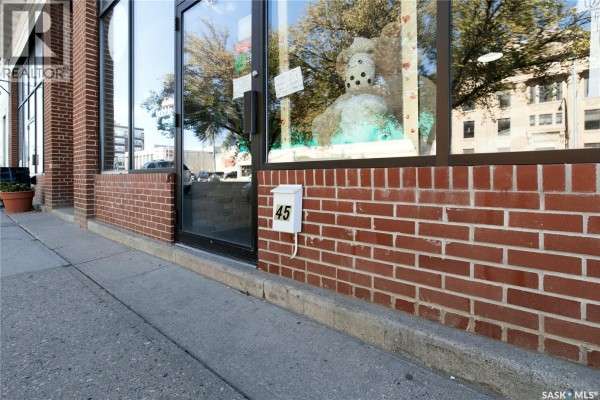 Close-up of a brick wall on a commercial building with a mailbox labeled "45". - 45 High Street W, Moose Jaw