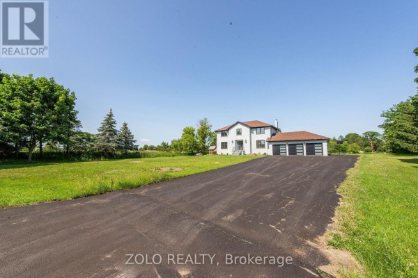 View of the house and property from a distance on a sunny day with green grass. - 45 Hilda Road, King