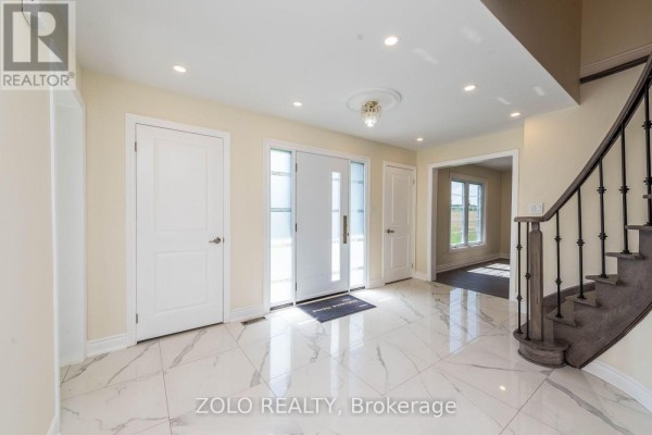 A living room with large windows, light yellow walls, and dark grey laminate flooring. - 45 Hilda Road, King