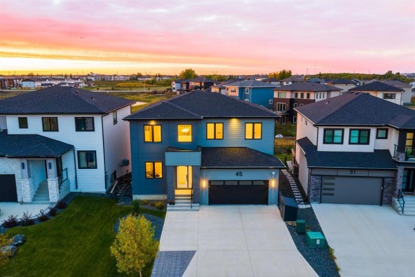 Aerial view of a modern two-story house with dark blue siding and a grey entrance. - 45 Karschuk Bay, Winnipeg