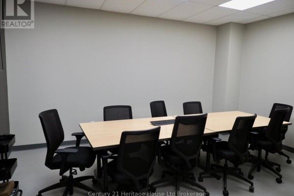 Conference room with a large light wood table and black mesh chairs. - 45 Metcalf Street, Woodstock