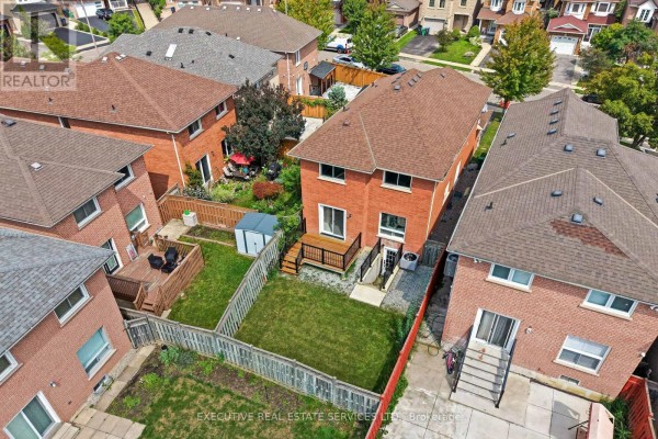 Backyard with wooden deck, shed, and lawn - 45 Sahara Trail Brampton