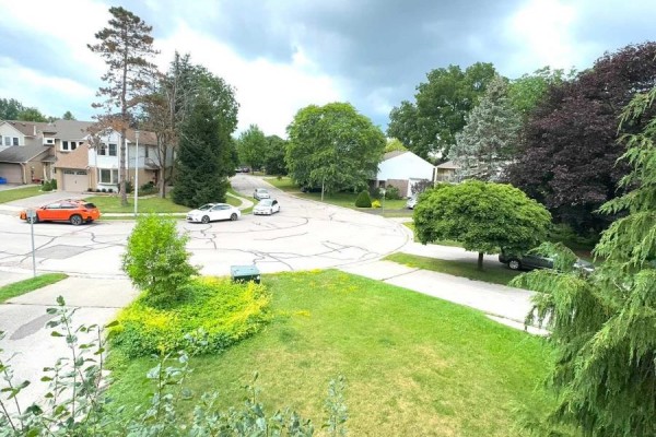 View from a high vantage point of a quiet suburban street with houses and mature trees. - 45 Sandusky Crescent, Aurora