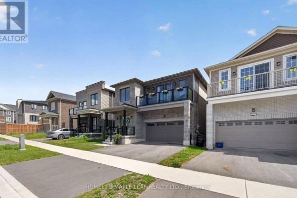 Street view of a row of modern houses, including the property at 45 Wheatfield Road, with driveways and sidewalks. - 45 Wheatfield Road, Barrie