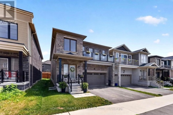 Side view of the property at 45 Wheatfield Road, showcasing its modern exterior, garage, and balcony with neighboring houses. - 45 Wheatfield Road, Barrie