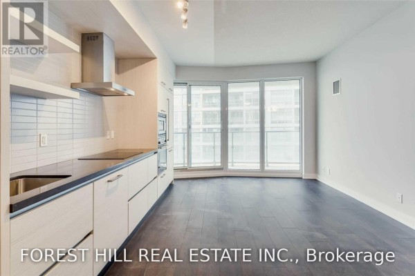 Kitchenette and living area in a modern apartment with large windows. - 4505 - 2221 Yonge Street, Toronto