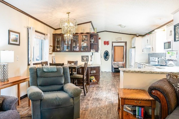 Open living and dining area with dark wood accents and modern appliances - 4505 Mclean Creek Road Unit# C11, Okanagan Falls