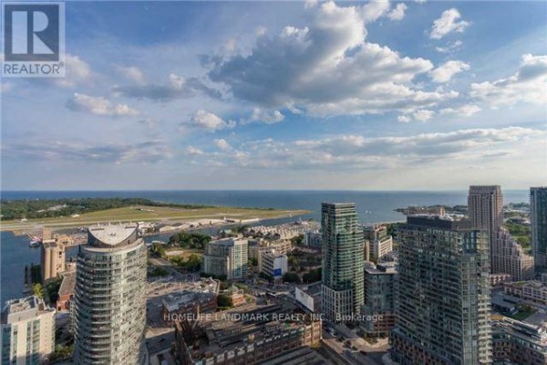 Aerial view of Toronto cityscape, waterfront, and islands on a cloudy day. - 4506 - 85 Queens Wharf Road, Toronto