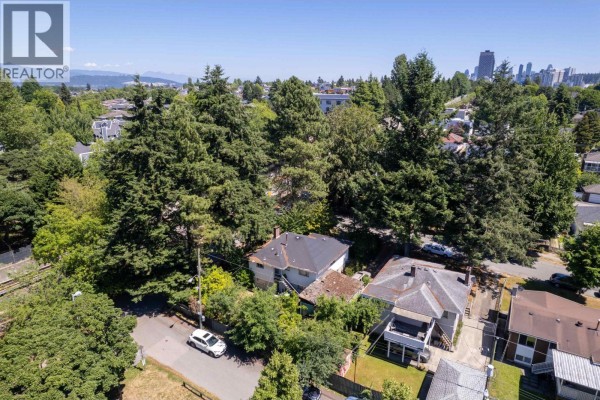 Overhead view of residential houses on Todd Street, surrounded by mature trees and a train track. - 4507 Todd Street, Vancouver