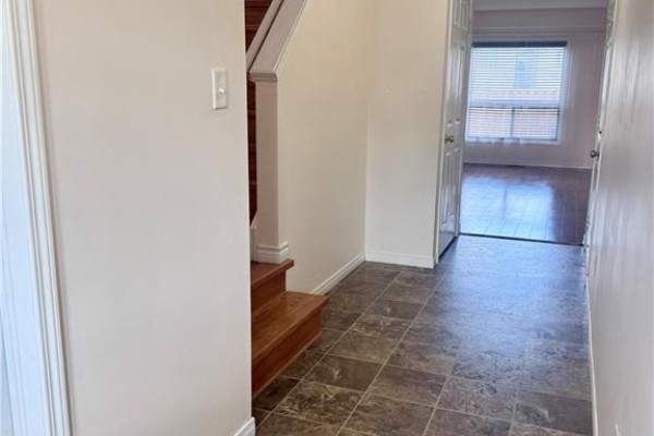 Interior hallway with a tiled floor, leading to an open doorway with blinds. - 452 Beaumont Crescent, Kitchener