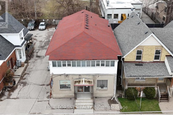 Aerial view of a two-story commercial building with a red shingle roof, surrounded by other properties. - 452 Horton Street, London East