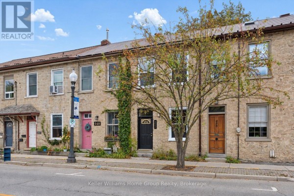 Front exterior view of a row of stone townhouses, highlighting units 448, 452, and 456. - 452 St Andrew Street W, Centre Wellington