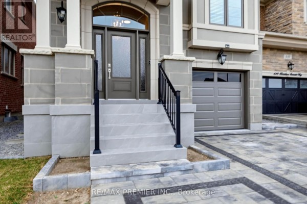 Close-up of the front entrance steps and door of a gray and stone house. - 453 Kleinburg Summit Way, Vaughan