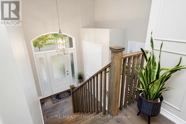 View from above of an entryway with a staircase, chandelier, and front door. - 453 Kleinburg Summit Way, Vaughan