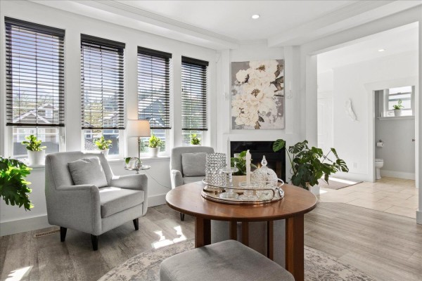 Living room with gray armchairs, round coffee table, and a fireplace. - 45425 Ariel Place, Vedder Mountain, Cultus Lake