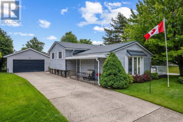 Aerial view of the property showing the house, detached garage, backyard, and surrounding street intersections. - 455 Bruce Street, Saugeen Shores