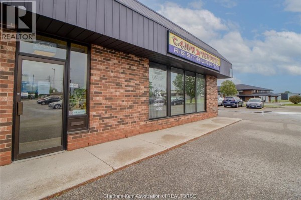 Side view of Cajun Pepper II Restaurant storefront with glass door and windows. - 455 Grand Avenue East Unit# 11, Chatham