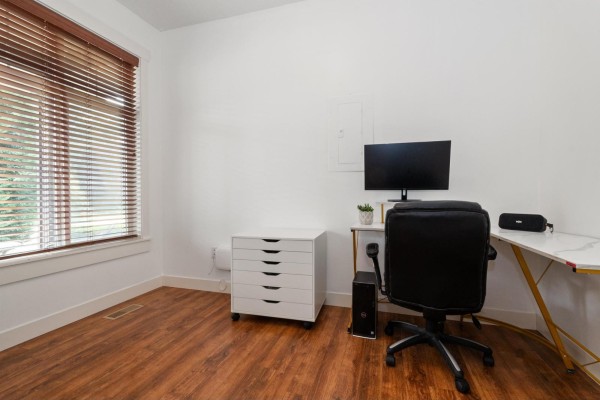 Small office room with white walls, wood floor, desk, and computer. - 45517 Wells Road, Sardis West Vedder, Chilliwack
