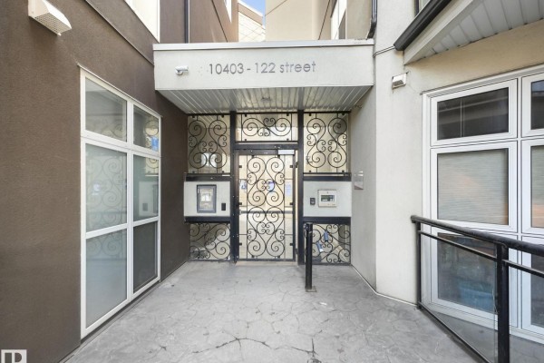 Main entrance to building 10403-122 Street with ornate metal gate and intercom. - #456 10403 122 St Nw, Edmonton