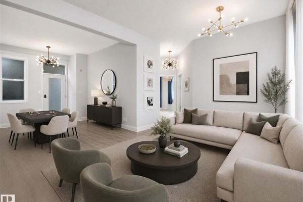 Living room with large windows, grey sofa, and light wood flooring. - #456 10403 122 St Nw, Edmonton