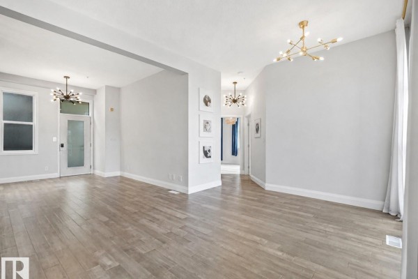 Small room with a glass door, frosted window, and light wood flooring. - #456 10403 122 St Nw, Edmonton
