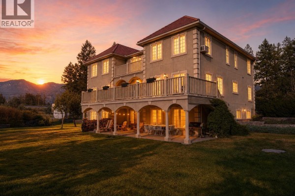 Rear exterior of the house with a large balcony and covered patio area. - 456 Lakeview Road, Invermere