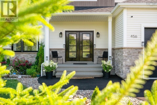 Spacious backyard with fire pit area, gravel surface, and surrounding trees - 456 Magenta Drive, Middle Sackville