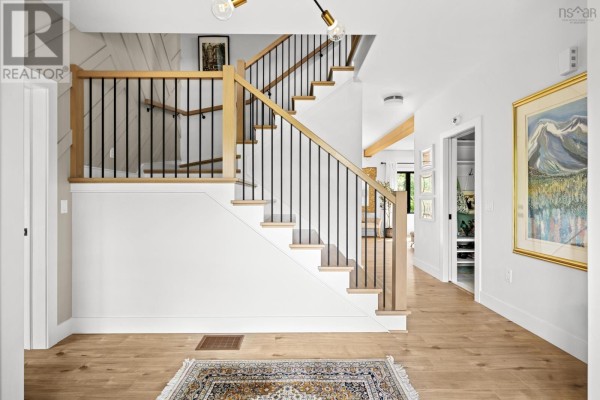 Welcoming foyer with staircase, hardwood flooring, and bench seating - 456 Magenta Drive, Middle Sackville