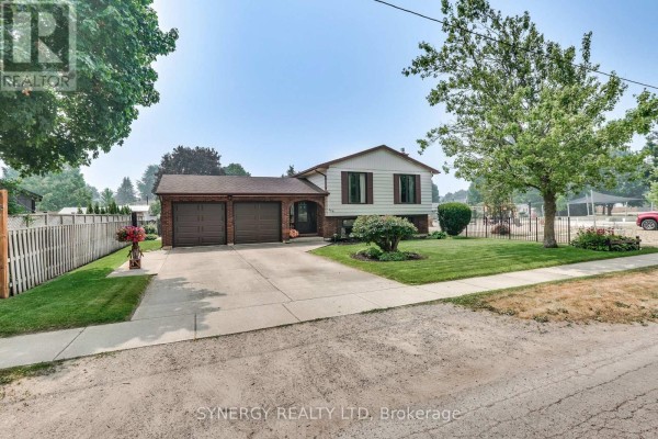 Street view of a residential house with a concrete driveway and manicured lawn. - 456 Saulsbury Street, Strathroy Caradoc