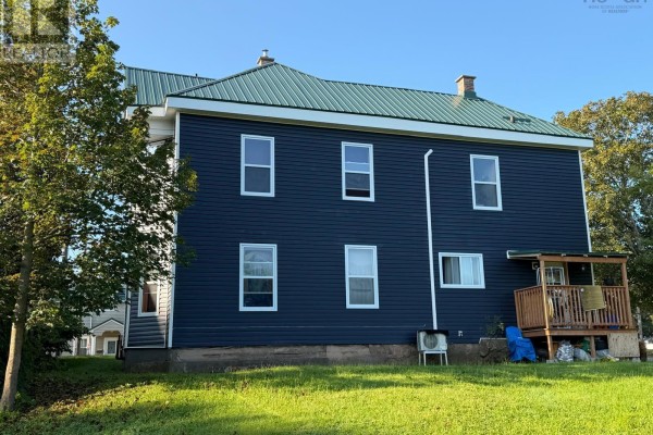 Back of the multi-family house with a green roof and windows on the second story. - 457 Robie Street, Truro