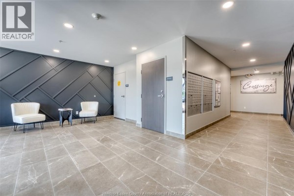 Apartment building lobby with tiled floor, mailboxes, and entrance doors. - 4578 Huron Church Line Road Unit# 502, Lasalle