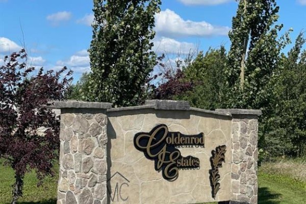 Stone entrance sign for Goldenrod Estates with trees in the background. - 46, 721022 Range Road 54, Rural Grande Prairie No  1, County Of