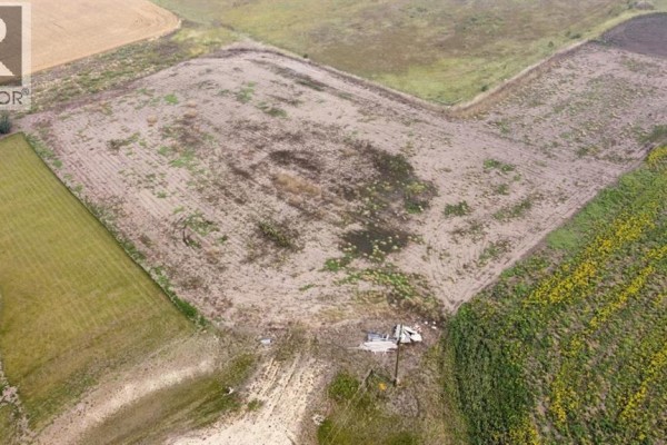 Aerial view of cleared land with a utility pole and some debris. - 46, 721022 Range Road 54, Rural Grande Prairie No  1, County Of