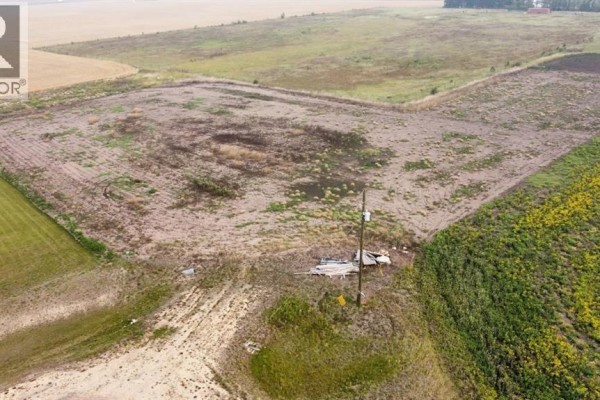 Aerial view of cleared agricultural land with surrounding fields and trees. - 46, 721022 Range Road 54, Rural Grande Prairie No  1, County Of