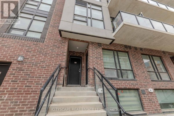Concrete steps with black railings ascend to the entrance of a brick townhouse. - 46 - 871 Sheppard Avenue W, Toronto