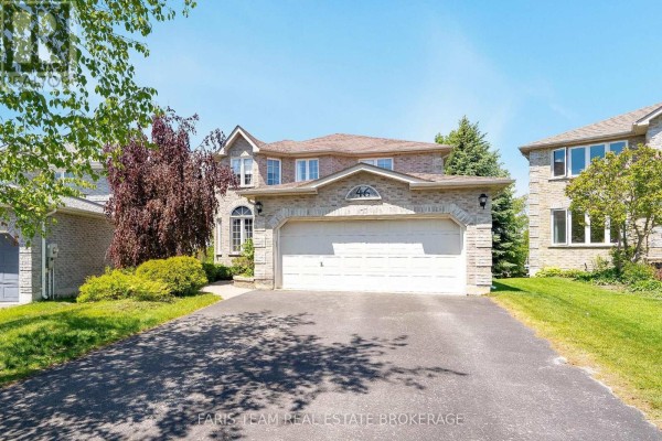 Street view of a large brick two-story house with a two-car garage and manicured lawn. - 46 Bell Street, Barrie